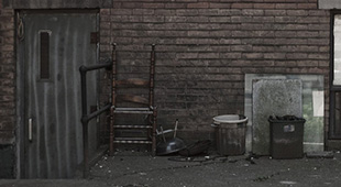 a depressing photo that was taken of garbage piled outside a building in Toronto